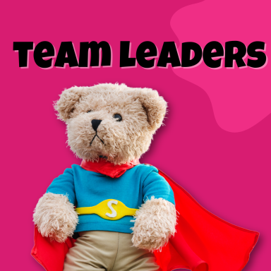 A teddy bear dressed as a superhero with a red cape on a pink background.
